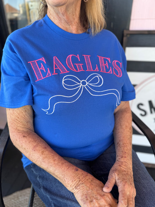 Person wearing a blue t-shirt with 'EAGLES' printed on it.