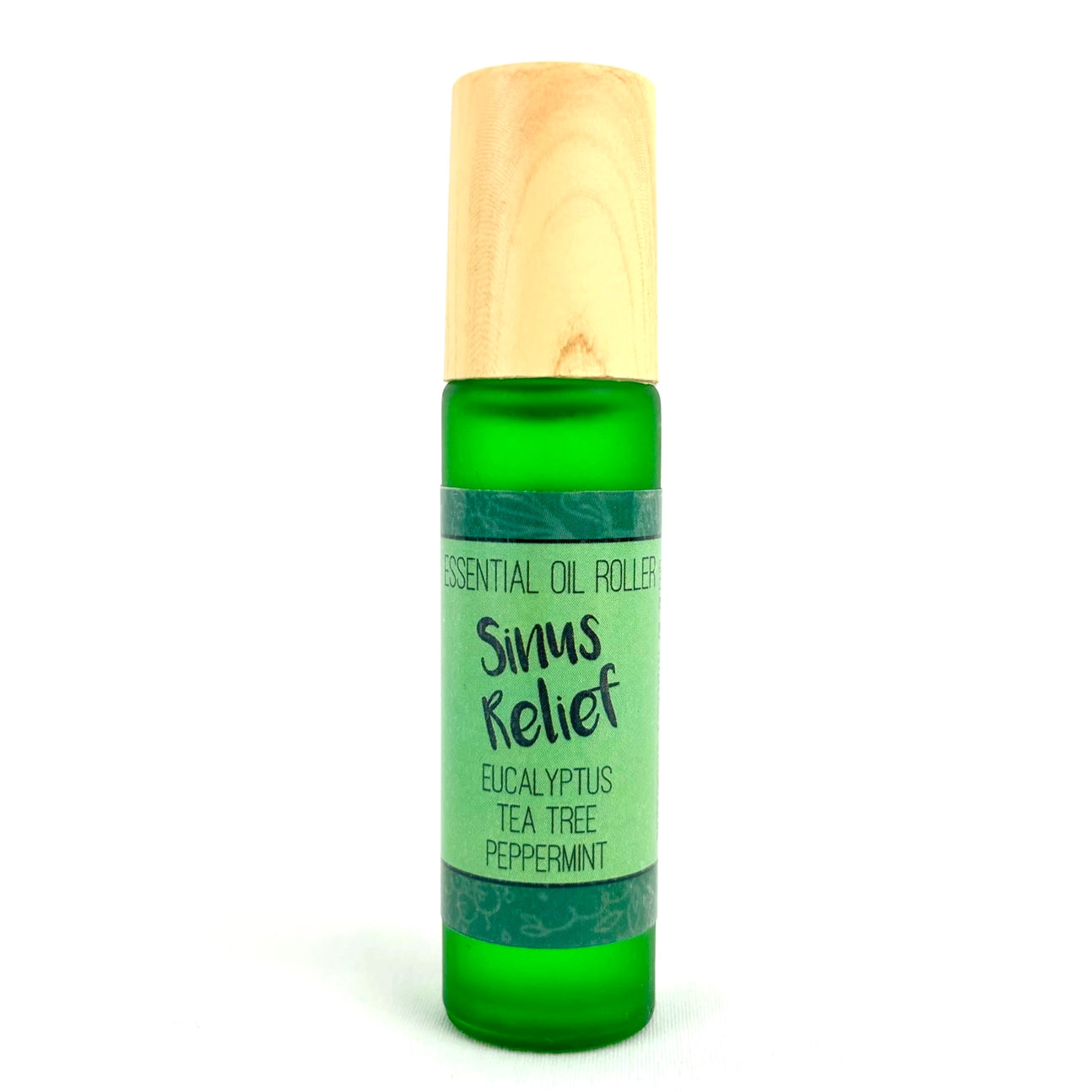 A green essential oil roller bottle with a light wood cap, labeled 'Sinus Relief' with eucalyptus, tea tree, and peppermint, on a white background.