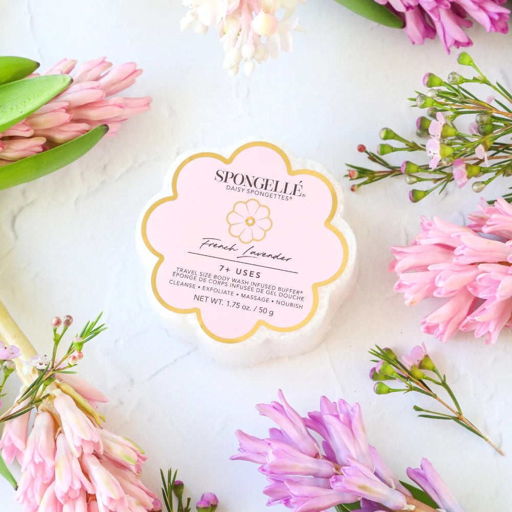 Spongellé product with French Lavender label surrounded by flowers on a light background