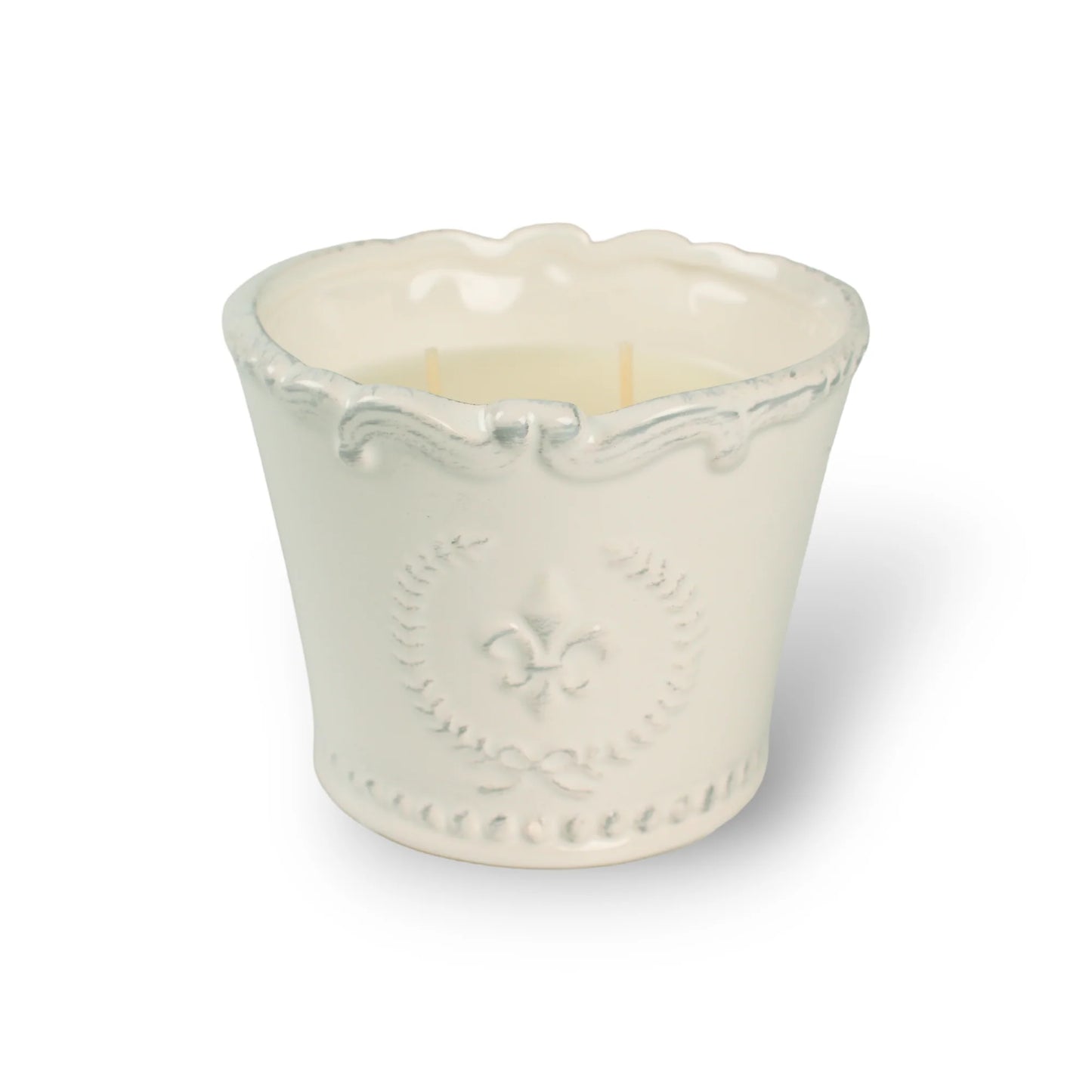 White ceramic candle holder with a candle inside on a white background