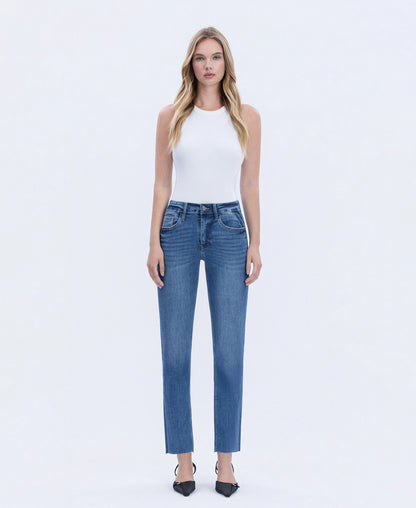 Woman wearing blue jeans and a white top on a white background