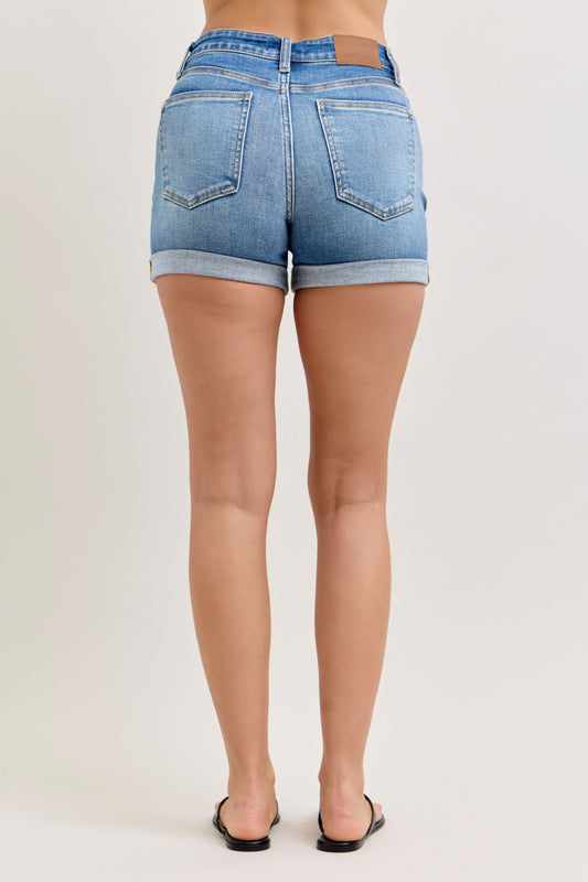 Light blue denim shorts worn by a person on a plain background