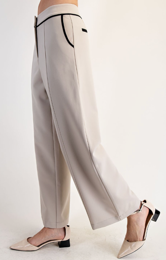 Light gray pants with black trim worn by a person on a white background