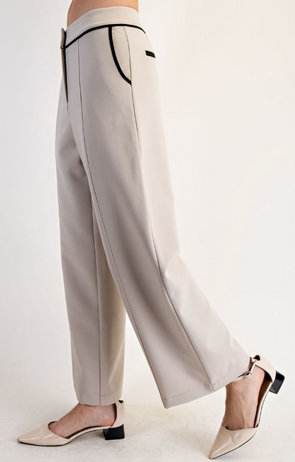 Light gray pants with black trim worn by a person on a white background