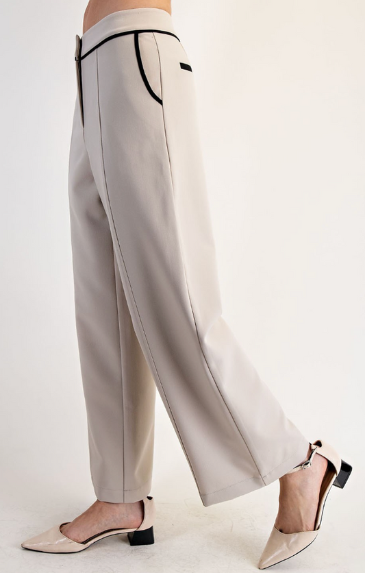 Light gray pants with black trim worn by a person on a white background