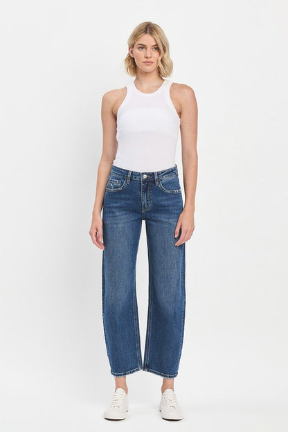 Woman wearing a white tank top and blue jeans on a white background