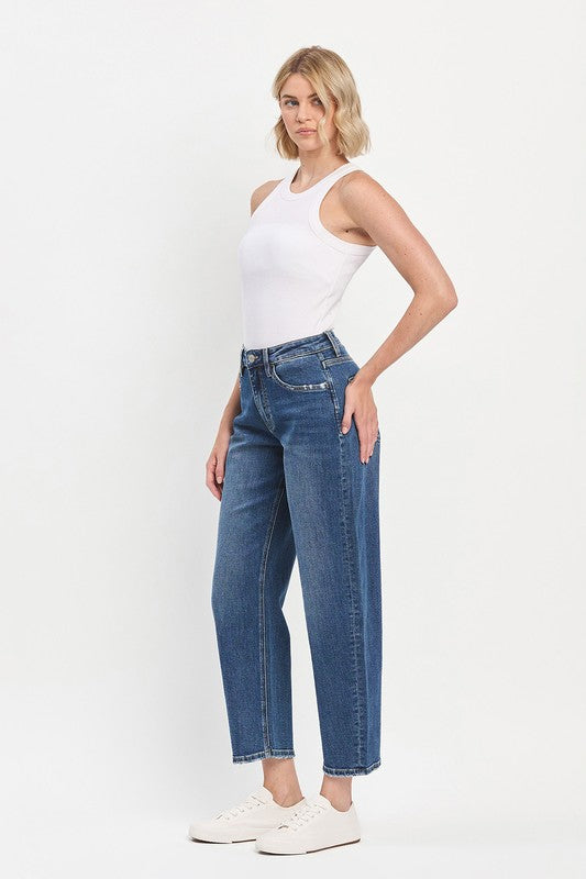 Woman wearing blue jeans and a white top on a white background