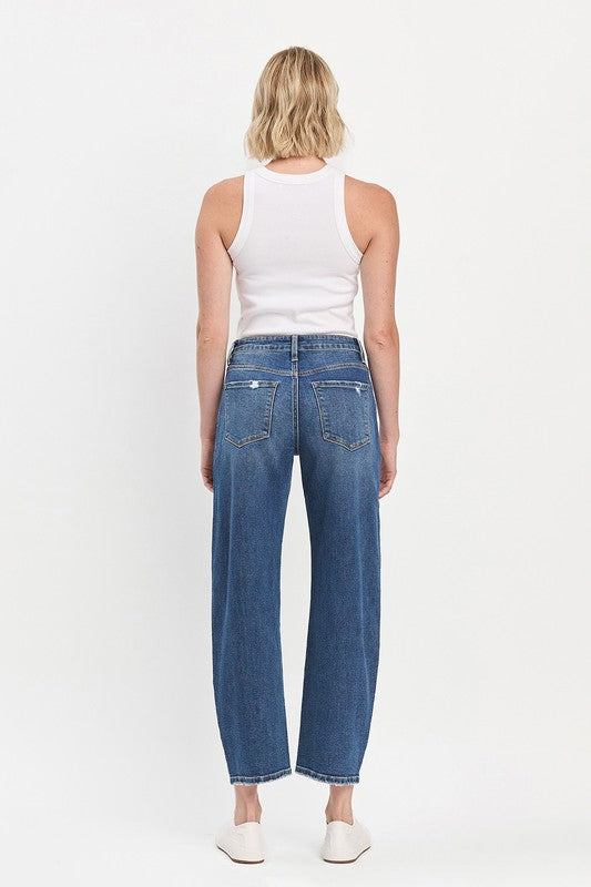 Person wearing blue jeans and a white tank top on a white background