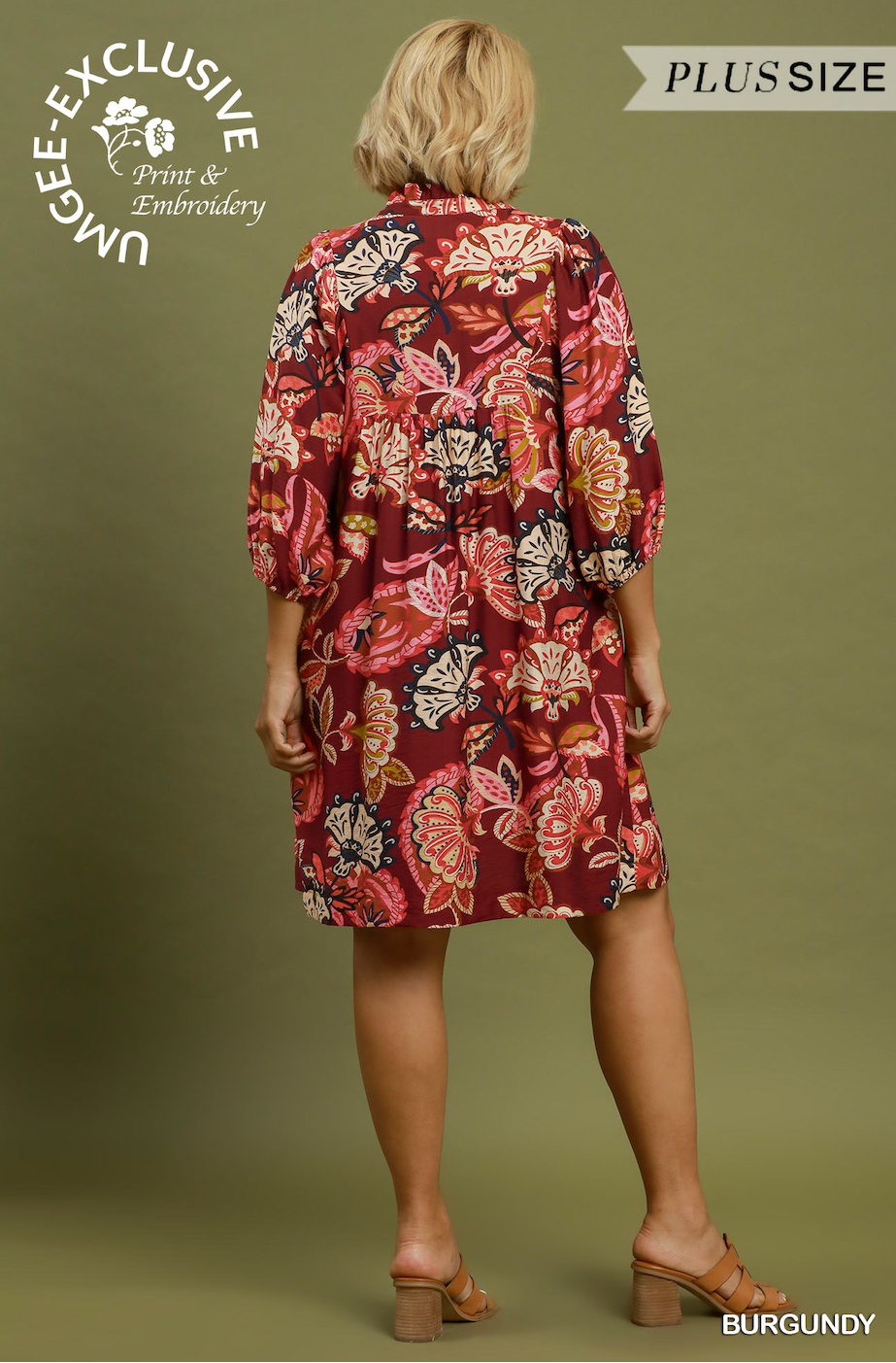 A woman shown from the back wearing a burgundy floral print shirt dress with three-quarter sleeves and a tie waist, standing against an olive green background. Text overlays include 'UNGEE-EXCLUSIVE Print & Embroidery', 'PLUSSIZE', and 'BURGUNDY'.