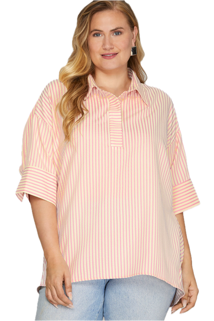Woman wearing a pink and white striped shirt with rolled-up sleeves on a white background