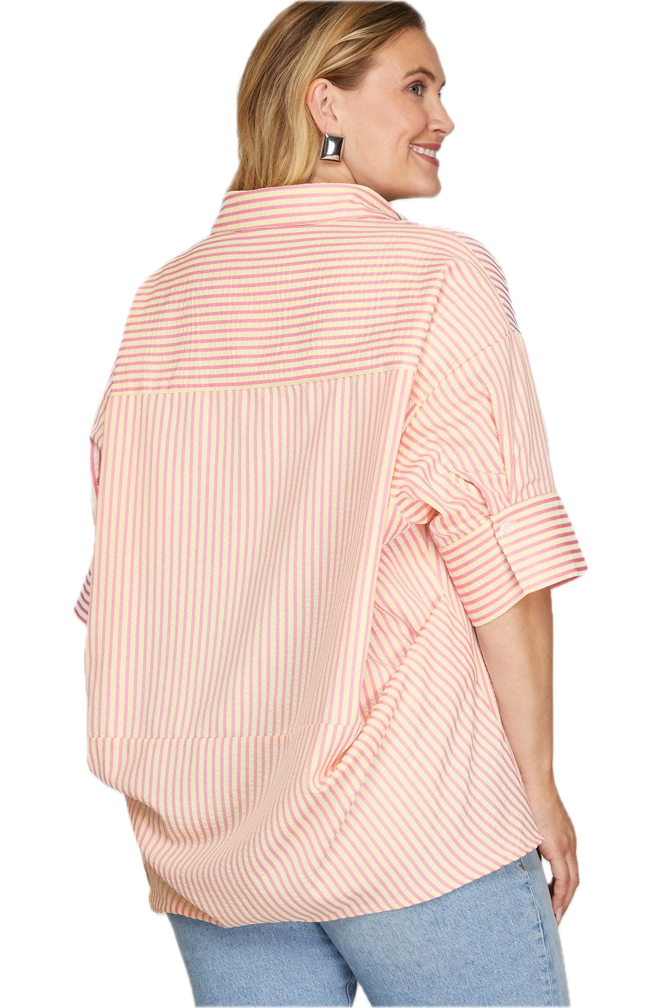 Woman wearing a pink striped shirt with rolled-up sleeves on a white background