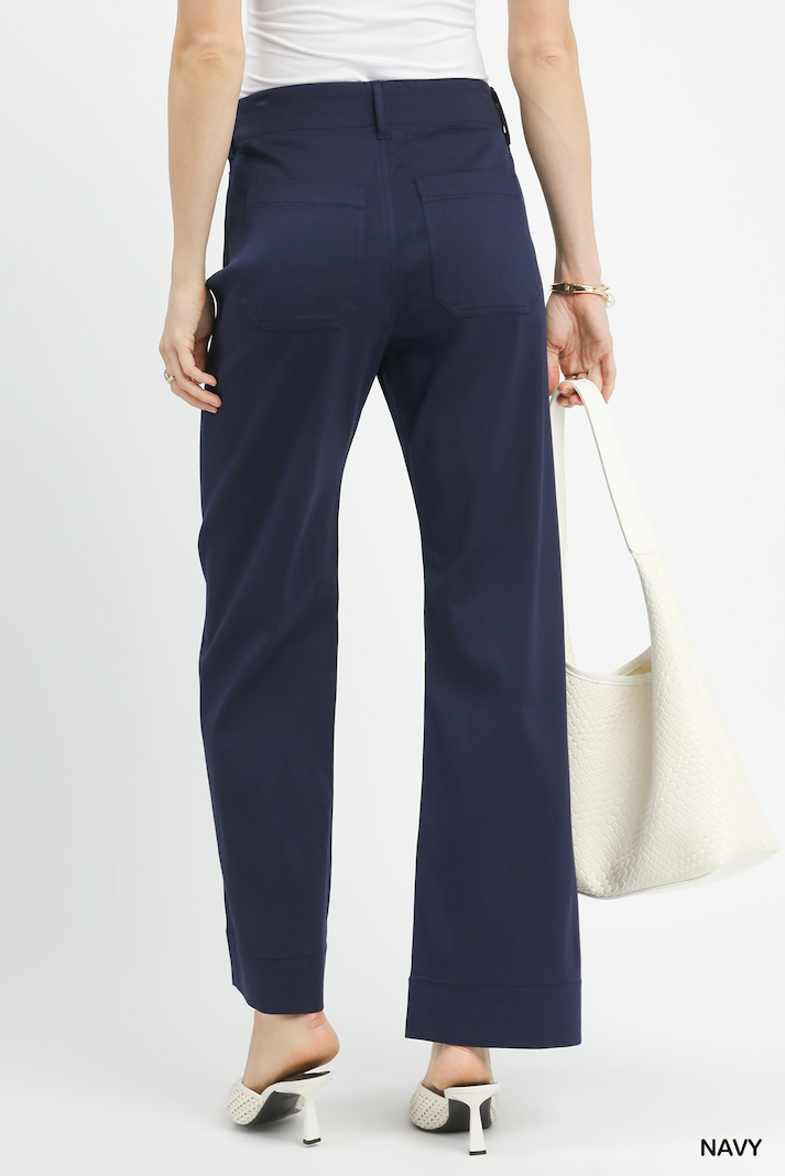 Navy pants worn by a person on a white background