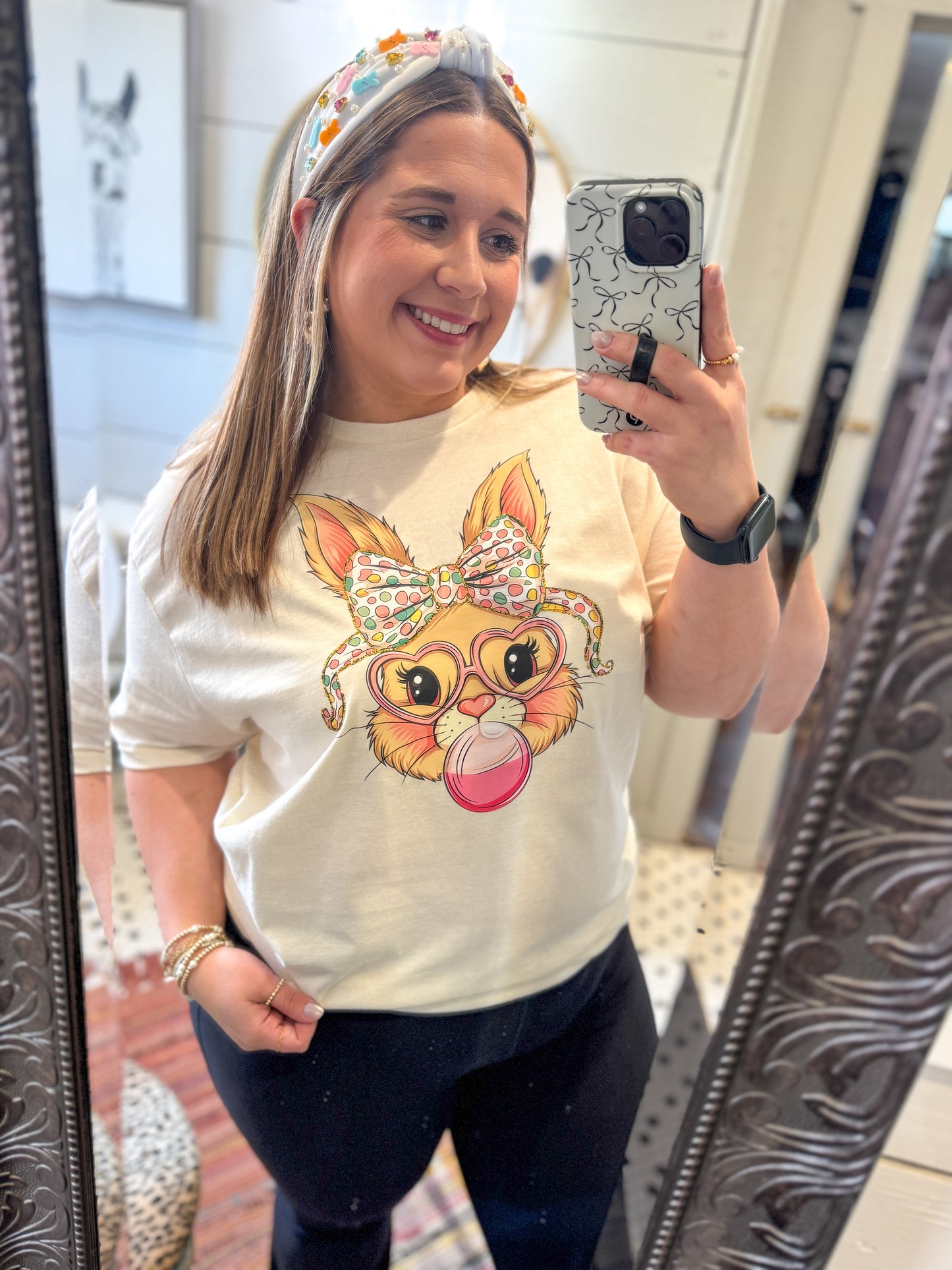 Woman taking a mirror selfie wearing a t-shirt with a cartoon fox design.