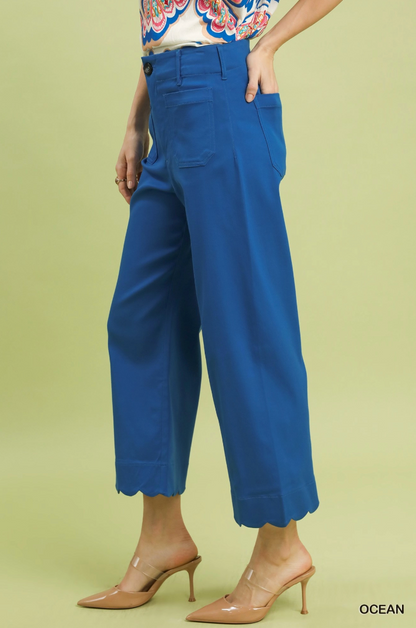 Blue pants worn by a person on a light green background