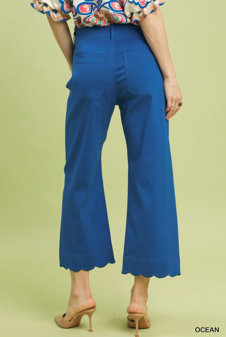 Blue pants worn by a person on a light green background