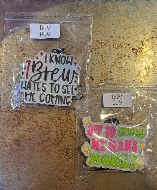 Two small signs in clear packaging on a textured surface