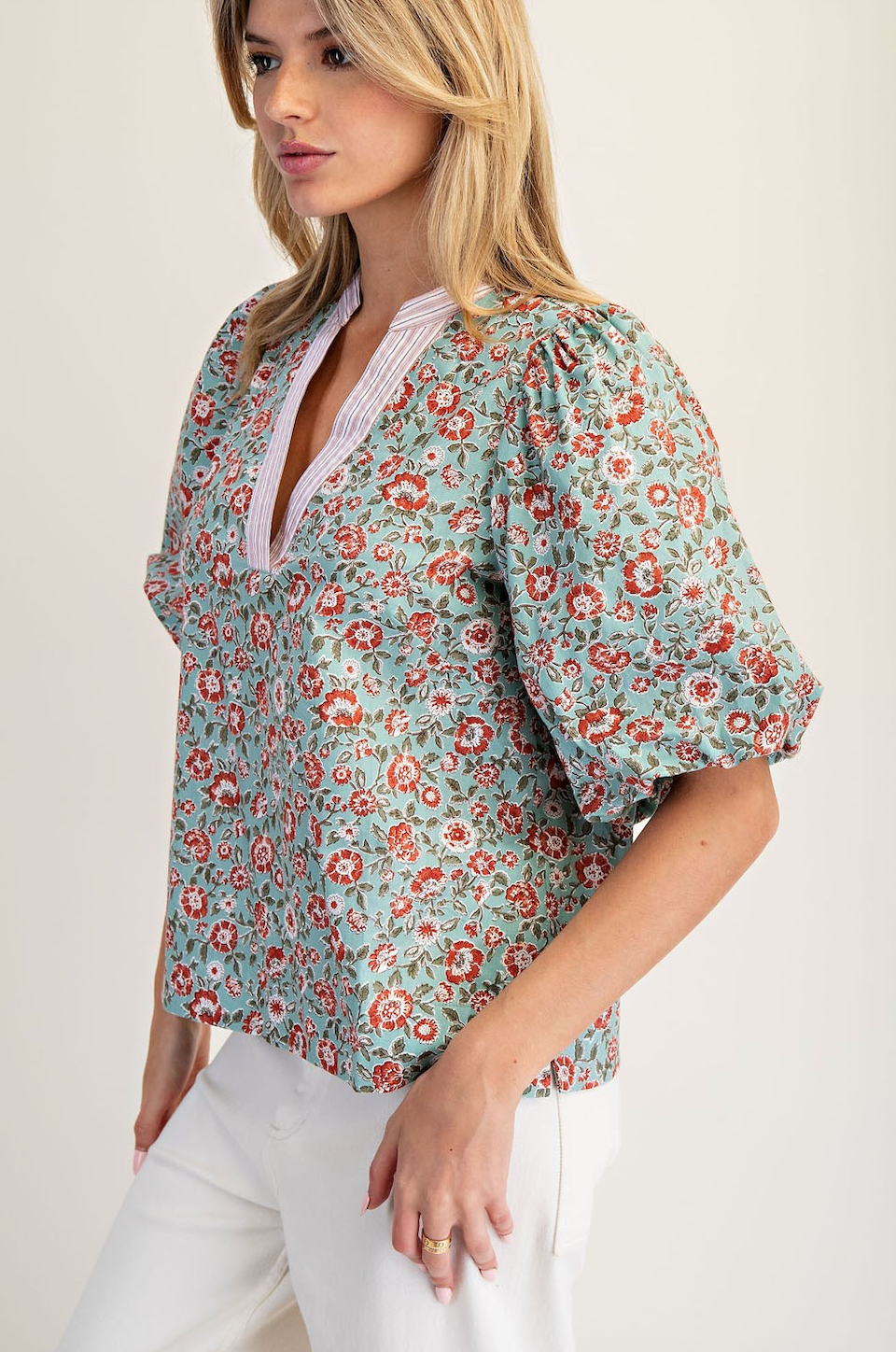 Woman wearing a floral blouse with a plain background