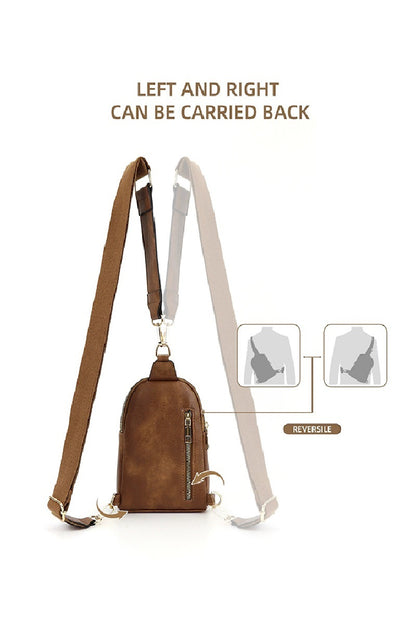 Brown and beige reversible sling bag with carrying straps on a white background