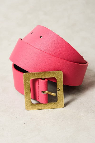 Pink belt with a gold buckle on a beige background