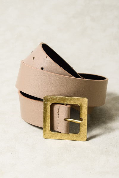 Beige leather belt with a gold buckle on a light background