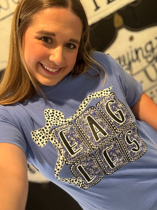 Person wearing a blue t-shirt with decorative text design