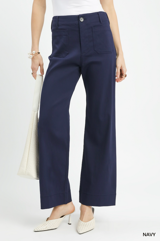Navy pants worn by a person on a white background