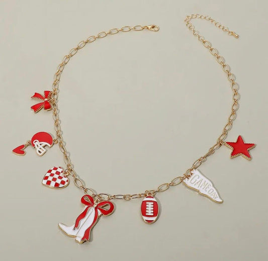 Gold bracelet with red and white charms on a beige background