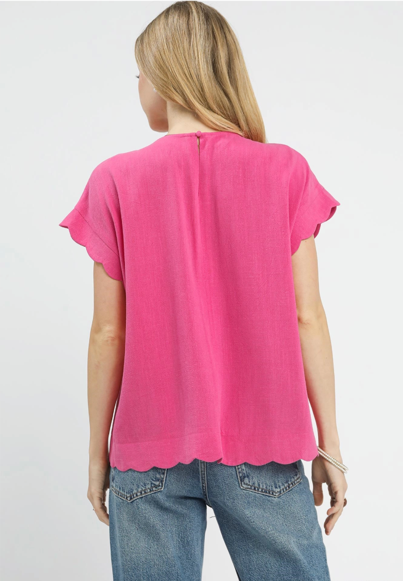 Person wearing a pink top and blue jeans on a white background