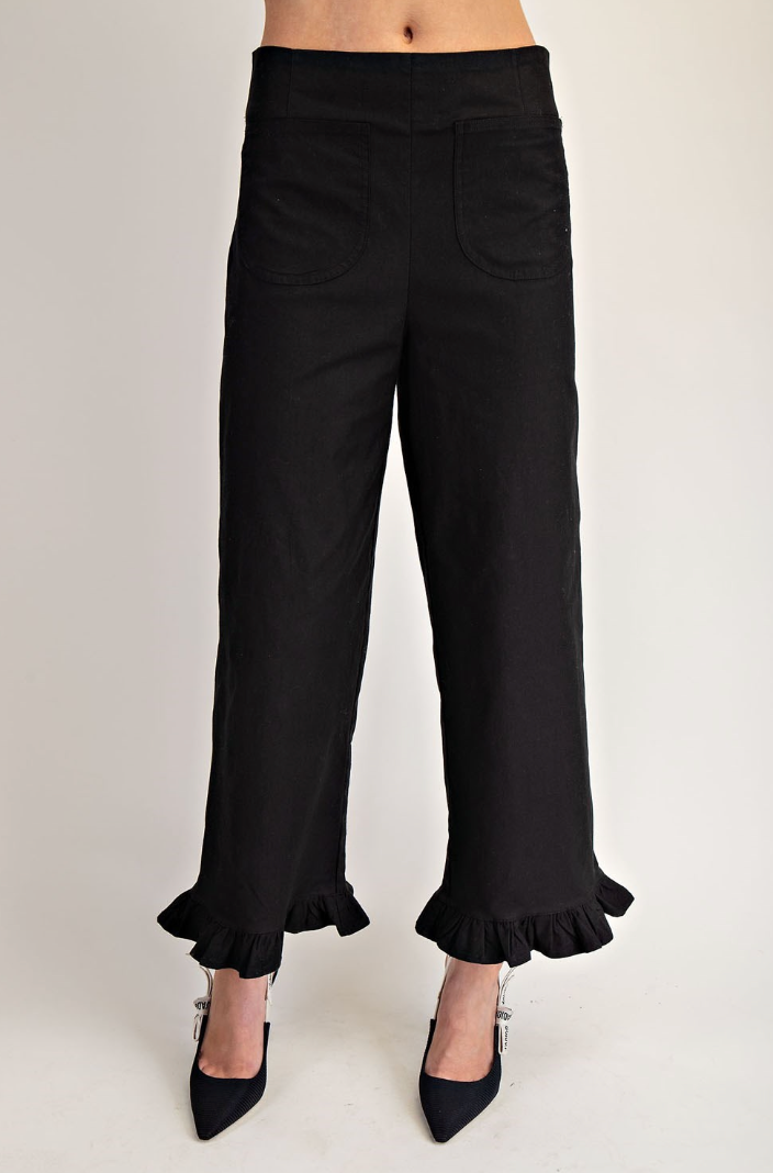 Black ruffled pants on a white background