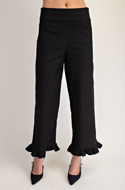 Black ruffled pants on a white background