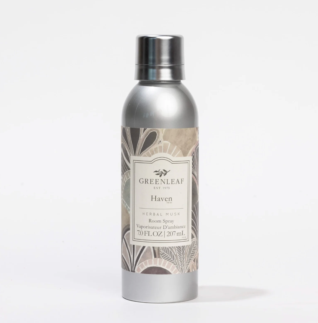 A silver aluminum spray bottle of Greenleaf Herbals 'Haven' Herbal Musk Room Spray, featuring a botanical pattern label and a metallic silver cap, set against a plain white background.