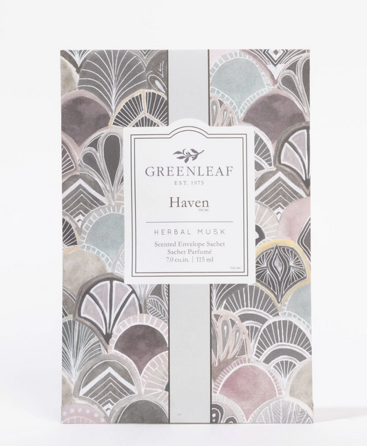 Greenleaf Haven Herbal Musk scented envelope sachet in a patterned paper sleeve with a central white label, photographed on a clean white background.