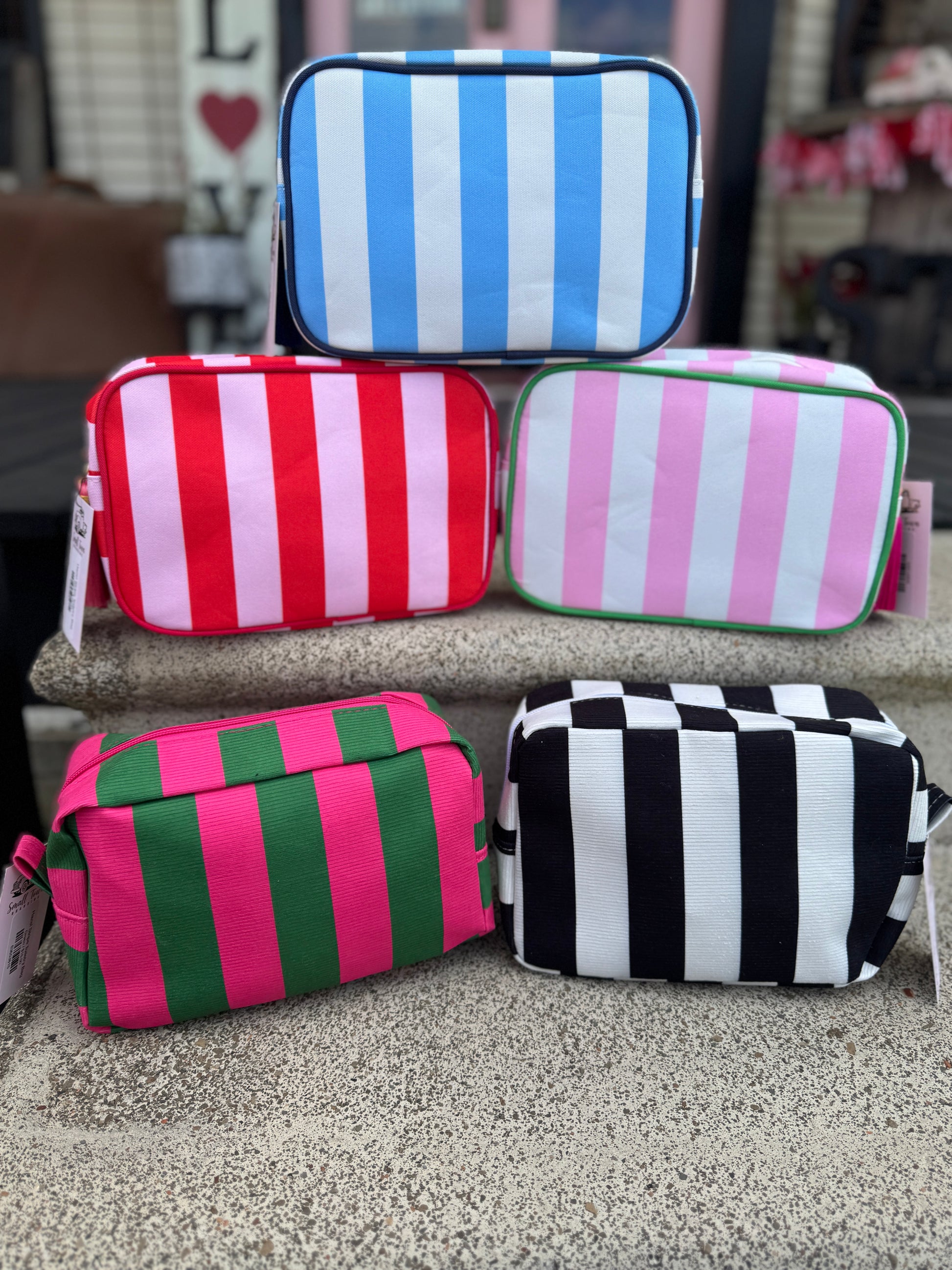Set of striped pouches in various colors on a surface.