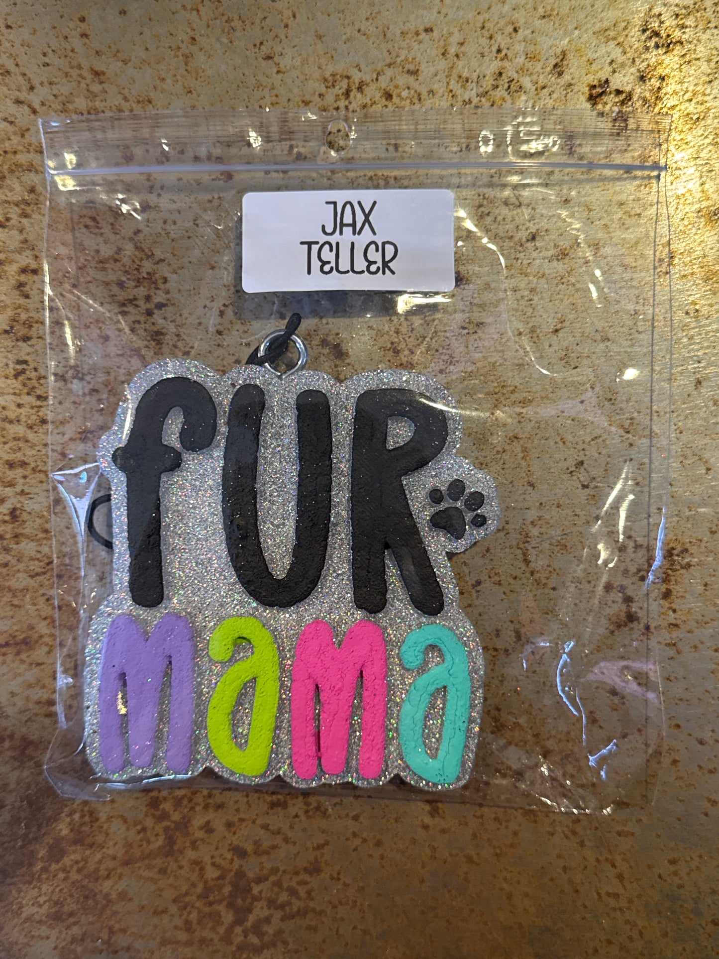 Packaged decorative item with 'fur mama' text on a textured surface