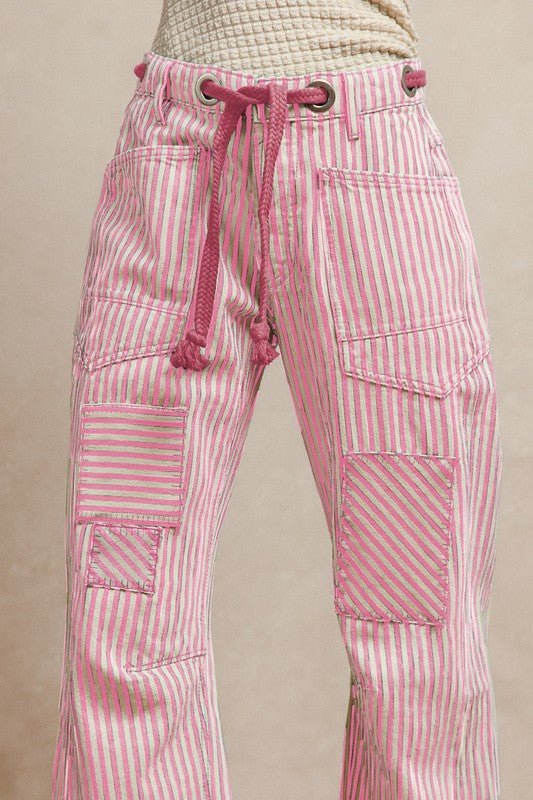 Pink striped pants with a drawstring on a beige background