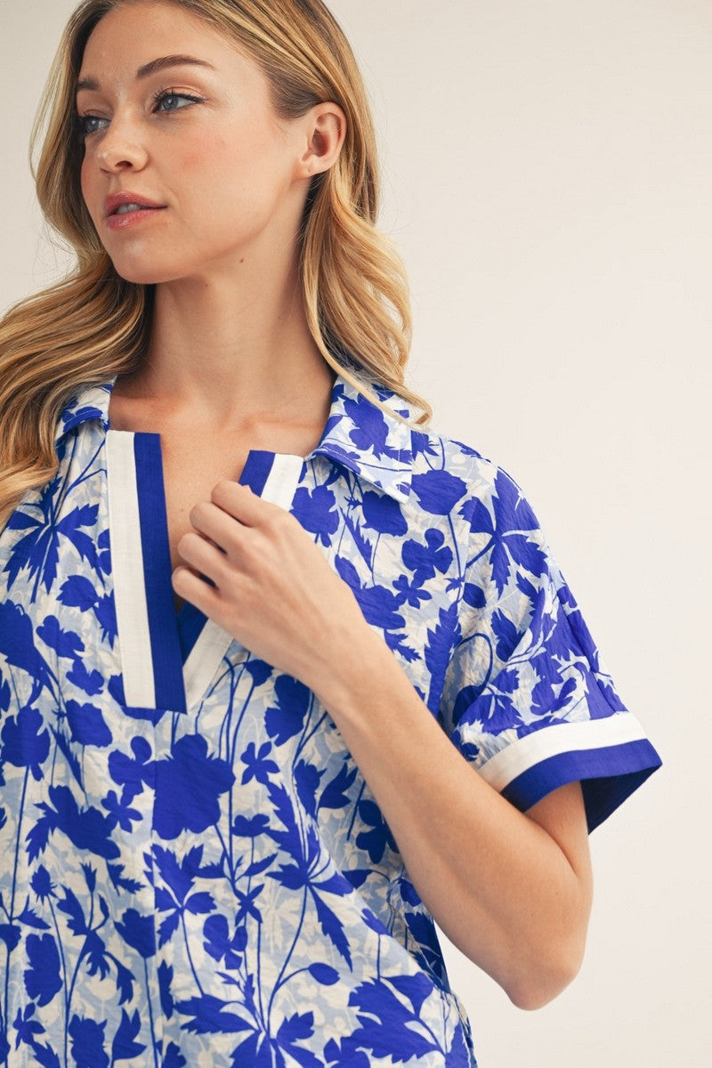 Woman wearing a blue floral dress with white background