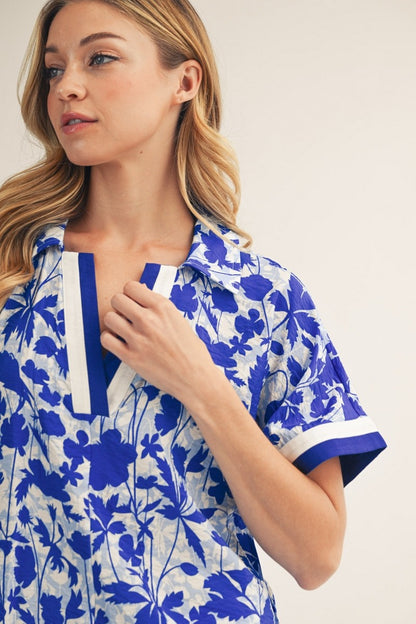 Woman wearing a blue floral dress with white background