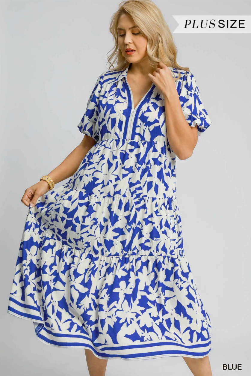 Woman wearing a blue and white floral dress on a gray background