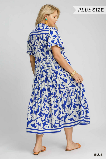 Woman wearing a blue and white floral dress on a gray background