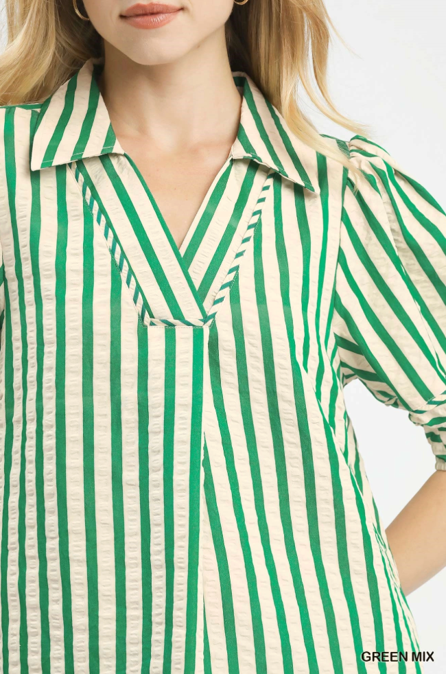 Green and white striped shirt worn by a person