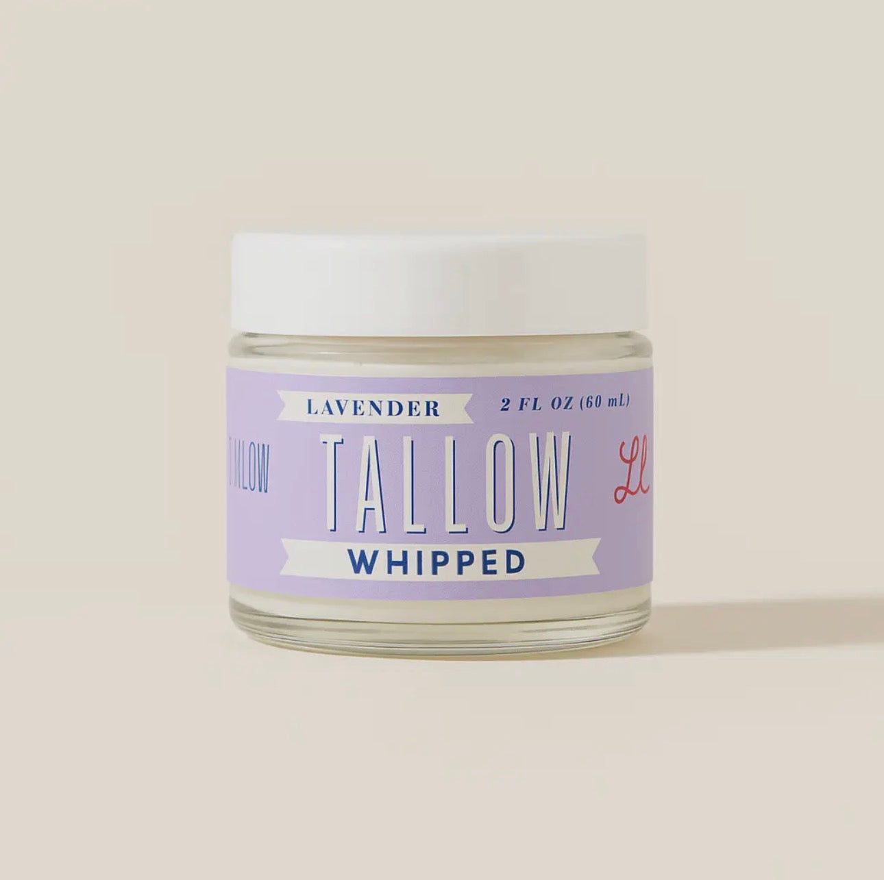 Jar of lavender tallow whipped product on a light beige background