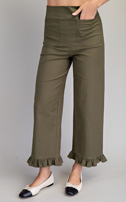 Green pants with ruffled hem on a gray background
