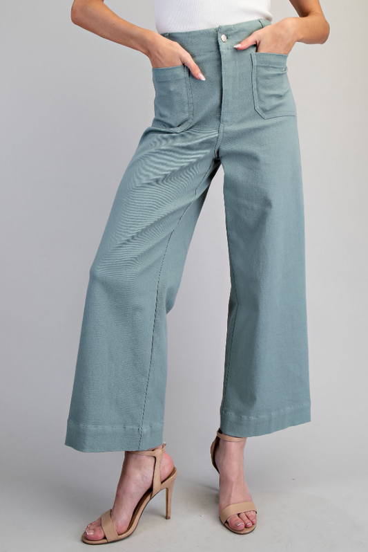 Light blue pants worn by a person on a gray background