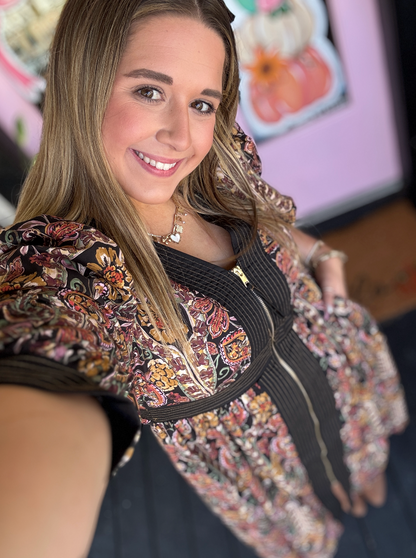 Woman wearing a floral blouse with a blurred background