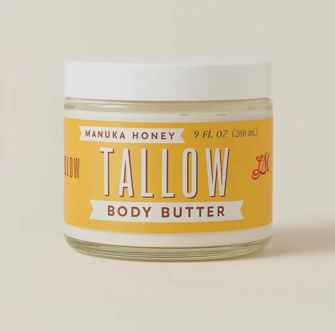 Jar of Manuka Honey Tallow Body Butter on a beige background