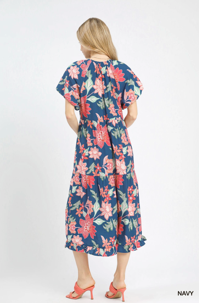 Woman wearing a navy floral dress on a white background