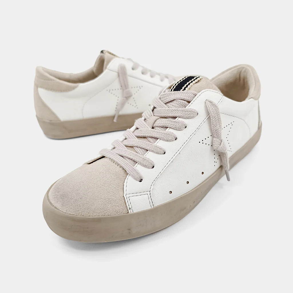 Pair of white and beige sneakers on a light background