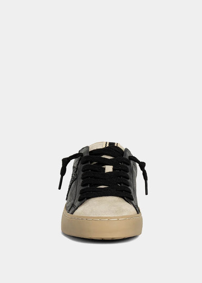 Black and beige sneaker on a light gray background