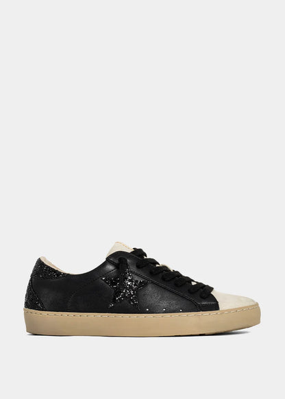 Black sneaker with beige sole on a white background