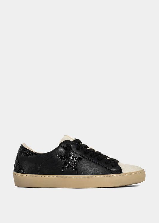 Black sneaker with beige sole on a white background